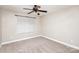 This bedroom features neutral walls, carpet, a dark ceiling fan and a window letting in natural light at 11005 Magna Ln, Indian Trail, NC 28079
