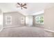 Expansive bonus room with multiple windows, vaulted ceilings, and neutral carpeting, perfect for flexible use at 11005 Magna Ln, Indian Trail, NC 28079