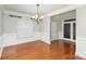 Dining room featuring hardwood floors, a decorative chandelier, and a large window at 11005 Magna Ln, Indian Trail, NC 28079