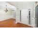 Bright entryway features a white front door and millwork, leading into the dining room with hardwood floors at 11005 Magna Ln, Indian Trail, NC 28079
