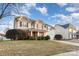 Inviting two-story home featuring neutral siding, well-kept lawn, and landscaping in a suburban neighborhood at 11005 Magna Ln, Indian Trail, NC 28079