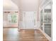 Open foyer with high ceilings, wood-look floors, white trim, and transom windows above the front door at 11005 Magna Ln, Indian Trail, NC 28079