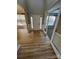 Bright foyer featuring hardwood flooring, transom windows, and a view into a sunlit room at 11005 Magna Ln, Indian Trail, NC 28079