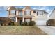 Charming two-story home with stone accents, covered porch, manicured landscaping, and a two-car garage at 11005 Magna Ln, Indian Trail, NC 28079