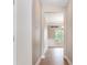 Hallway with hardwood floors leading to living room and backyard view at 11005 Magna Ln, Indian Trail, NC 28079