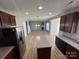 Modern kitchen featuring stainless steel appliances, a central island, and an open concept layout at 11005 Magna Ln, Indian Trail, NC 28079