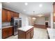 Bright kitchen featuring stainless steel appliances, center island, and tile flooring at 11005 Magna Ln, Indian Trail, NC 28079