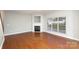 Staged living room showcasing fireplace, large window, and neutral decor at 11005 Magna Ln, Indian Trail, NC 28079