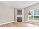 Cozy living room with fireplace, wood-look floors, neutral walls, and a bright window at 11005 Magna Ln, Indian Trail, NC 28079