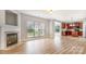 Open-concept living space with wood-look floors, fireplace, and an open view to the kitchen at 11005 Magna Ln, Indian Trail, NC 28079