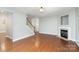 Spacious living room with hardwood floors and fireplace adjacent to the staircase at 11005 Magna Ln, Indian Trail, NC 28079