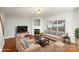 Staged living room featuring a fireplace, large window, sofas and chairs at 11005 Magna Ln, Indian Trail, NC 28079