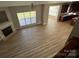 A view from the stairs showing the wood floors, living room fireplace, and an open kitchen area at 11005 Magna Ln, Indian Trail, NC 28079