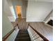 A view from the top of the staircase showing new carpet, wood flooring, and a glimpse into the bathroom at 11005 Magna Ln, Indian Trail, NC 28079