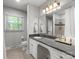 Well-maintained bathroom with a granite countertop, a large mirror, and tile flooring at 1102 Oak Hill Dr, Monroe, NC 28112
