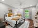 Inviting bedroom with a large window overlooking the backyard and stylish decor at 1102 Oak Hill Dr, Monroe, NC 28112