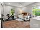 Cozy bedroom featuring a daybed, a Peloton exercise bike, and ample natural light at 1102 Oak Hill Dr, Monroe, NC 28112