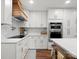 Updated kitchen with white cabinets, wood accents, stainless steel appliances, and large center island at 1102 Oak Hill Dr, Monroe, NC 28112