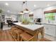 Open-concept kitchen featuring a large center island, seating, modern appliances, and hardwood floors at 1102 Oak Hill Dr, Monroe, NC 28112