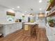 Modern kitchen with white cabinets, stainless appliances, center island with seating, and hardwood floors at 1102 Oak Hill Dr, Monroe, NC 28112