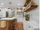 Well-lit kitchen with modern appliances, large island, and custom wooden shelving at 1102 Oak Hill Dr, Monroe, NC 28112