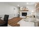 Cozy living area featuring a fireplace, hardwood floors, and white accents at 1102 Oak Hill Dr, Monroe, NC 28112