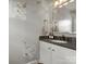 Stylish half-bath with designer wallpaper, granite countertop, and updated fixtures at 1102 Oak Hill Dr, Monroe, NC 28112