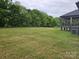 Large backyard with plenty of space for outdoor activities and mature trees around property line at 1215 Coppergate Dr, Salisbury, NC 28147