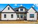 Charming farmhouse-style home with a symmetrical facade, accented by black trim and wood features at 1215 Coppergate Dr, Salisbury, NC 28147