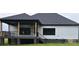Modern farmhouse with a covered porch, black framed windows, and a sleek, dark roof at 1215 Coppergate Dr, Salisbury, NC 28147