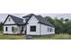 Exterior view of a modern two-story home with white siding, black trim, and a well-manicured lawn at 1215 Coppergate Dr, Salisbury, NC 28147