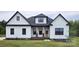 Charming new construction home featuring white siding, black trim and roof, and a welcoming front porch at 1215 Coppergate Dr, Salisbury, NC 28147