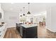 Open-concept kitchen with a large island, stainless steel appliances, and a seamless flow to the dining and living areas at 1215 Coppergate Dr, Salisbury, NC 28147