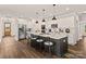 Modern kitchen with an island, stainless steel appliances, white cabinets, and pendant lighting at 1215 Coppergate Dr, Salisbury, NC 28147