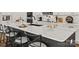 Modern kitchen featuring a large island with white countertops, sleek black cabinets, and stylish barstool seating at 1215 Coppergate Dr, Salisbury, NC 28147