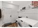 Well-organized laundry room with modern appliances, storage, and a convenient door leading outside at 1215 Coppergate Dr, Salisbury, NC 28147
