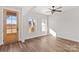 Bright, open living space with hardwood floors, ceiling fan, and natural light from large windows at 1215 Coppergate Dr, Salisbury, NC 28147