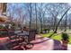 Inviting back deck with outdoor dining set, overlooking a serene, wooded yard with mature trees at 13101 Whisper Creek Dr, Charlotte, NC 28277
