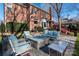 Outdoor living area with comfortable seating around a modern fire pit in a landscaped backyard at 13101 Whisper Creek Dr, Charlotte, NC 28277