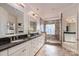Bathroom with a double sink vanity, granite countertops, and a walk-in shower with a glass block window at 13101 Whisper Creek Dr, Charlotte, NC 28277