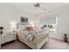 Bright bedroom features a window, ceiling fan, and a comfortably decorated bed with a floral blanket at 13101 Whisper Creek Dr, Charlotte, NC 28277
