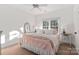 Bright bedroom featuring a window, ceiling fan, neutral carpet and light pink decor at 13101 Whisper Creek Dr, Charlotte, NC 28277