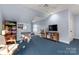 Bonus room with blue carpet, a ceiling fan and ample space for activities and relaxation at 13101 Whisper Creek Dr, Charlotte, NC 28277