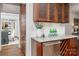 A butler pantry features custom cabinets, granite countertop, wine rack and a stylish serving area for sophisticated entertaining at 13101 Whisper Creek Dr, Charlotte, NC 28277