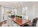 Bright dining area with a modern chandelier, large bay window, and a spacious layout for comfortable dining at 13101 Whisper Creek Dr, Charlotte, NC 28277