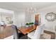 Stylish dining room with a wooden table, modern chandelier, neutral color scheme, and hardwood floors at 13101 Whisper Creek Dr, Charlotte, NC 28277