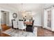 Elegant dining room with a stylish chandelier, statement art, and a contemporary rug, perfect for gatherings at 13101 Whisper Creek Dr, Charlotte, NC 28277