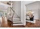 Inviting foyer with hardwood floors, a classic staircase, and a view into the formal dining area at 13101 Whisper Creek Dr, Charlotte, NC 28277