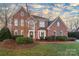 Charming two-story brick home with well-manicured lawn and decorative shutters at 13101 Whisper Creek Dr, Charlotte, NC 28277