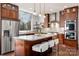 Modern kitchen features stainless steel appliances, custom cabinets, a large island, and sleek countertops for stylish cooking at 13101 Whisper Creek Dr, Charlotte, NC 28277